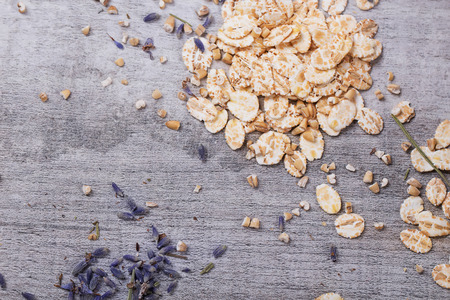 Various oat products on a kitchen table: cut oats, oatmeal crackers, oat milk. Kitchen tiles backgroundの写真素材