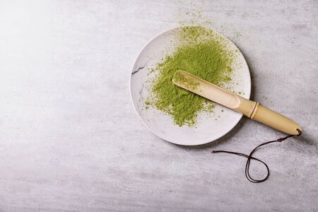 Matcha tea bamboo scoop over the plate. Top View Copy Spaceの写真素材