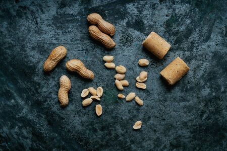 Sprinkled salted roasted peanuts, peanuts in a shell and brazilian peanut candy PaÃ§oca over...