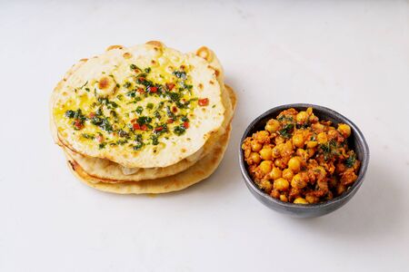 Traditional Indian flat bread Chapati served with Chimichurri sauce and bowl of Channa Masala. Selective focus.の写真素材