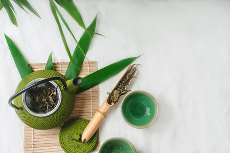 Chinenese dry tea leaves with teapot decorated with maple leaves. Relaxation Concept. Flat lay. Top Viewの写真素材