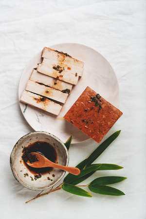 Raw Uncooked Cappelletti in a vintage olive tree scoop  and metal strainer over a metal background. Top View. Flat Layの写真素材
