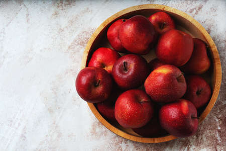 Apples starking in the mesh bag over a metal background. Sustainability and conscious consuming...