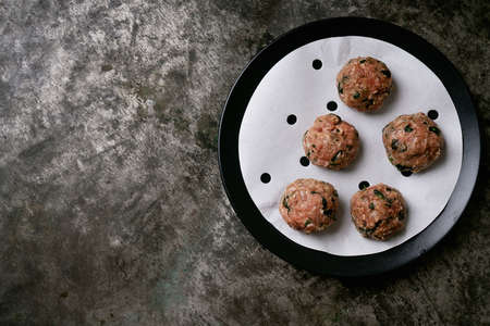 Ready to cook meatballs in asian bamboo steamer over a metal background. Top View. Flat Lay.の写真素材