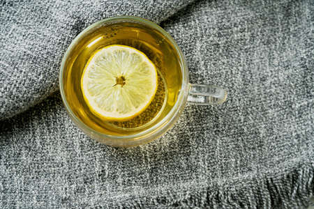 Lemon Verbena tea served with lemon over a grey blanket. Flat Lay. Top Viewの写真素材