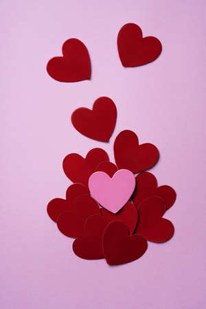 Pink and red hearts over a pink background. Minimalistic decoration concept. Flat Lay. Top View