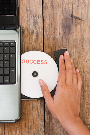 Success concept with compact disk and laptopの写真素材