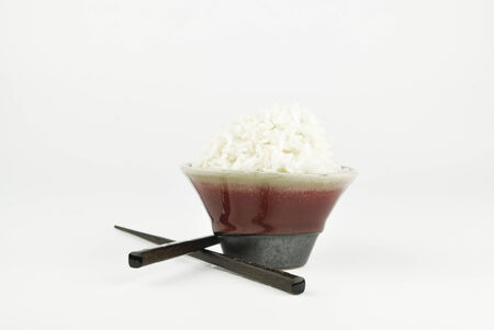 Rice in bowl and chopstick on white backgroundの写真素材