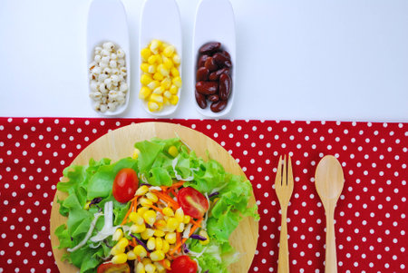 Fresh vegetable salad with corn,carrot,tomato,green oak,red oak,Red bean and milletの写真素材