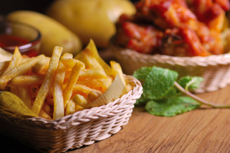 fried chicken wings with french fries and ketchupの写真素材