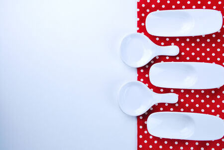 Wooden plate, tablecloth, spoon, fork on table backgroundの写真素材