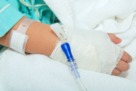 Hand of sick little girl at hospitalの写真素材