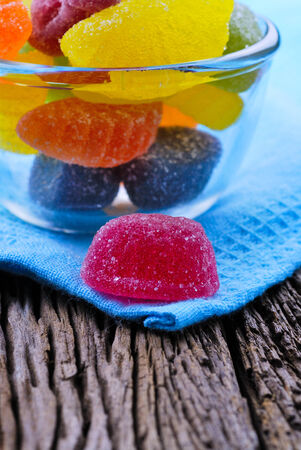 Color fruit jelly candies on wooden tableの写真素材