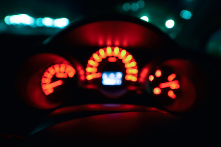 Abstract bokeh of car speed meter light dashboard with traffic  light at nightの写真素材