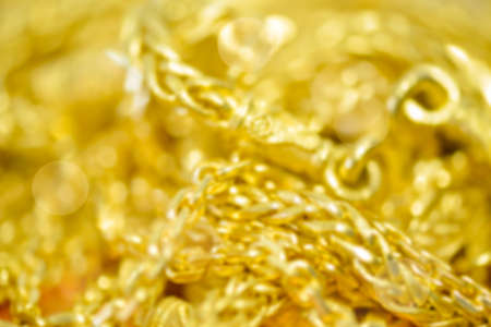 Blured defocused Gold necklaces , bracelets  and bokeh for gold backgroundの写真素材