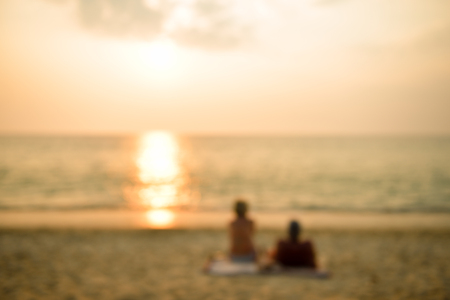 Blurred and soft focus romantic Couple Enjoying Sunset on Beautiful Tropical Beachの写真素材