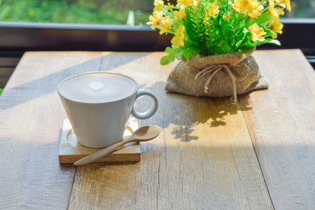 Hot latte coffee in glass  cup mug on wooden tableの写真素材