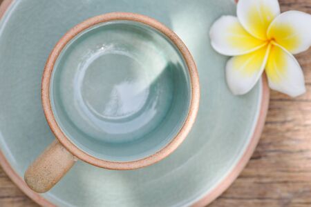 Empty coffee green cup on old wooden tableの写真素材
