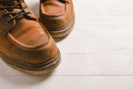 Old leather boot traditional leather style on wooden backgroundの写真素材