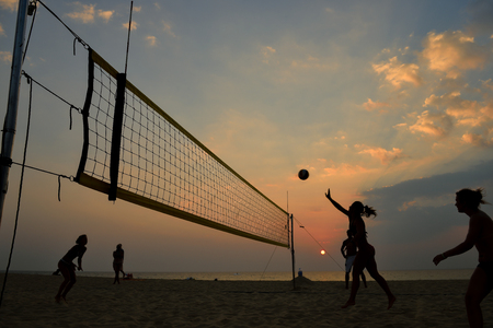 Beach volleyball silhouette at sunset , motion blurredの写真素材