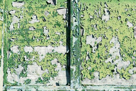 The old window with green closed shutters on an old house. Vintage background, texture. show scratched of old color.の写真素材