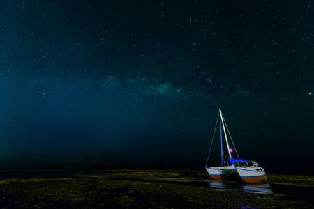 Milky way at rawai beach Phuket with boat on beachの写真素材