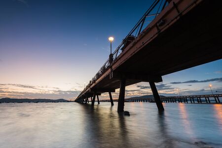 Bridge to the sea at sunrise, chalong harbor Phuket Thailand, long exposureの写真素材