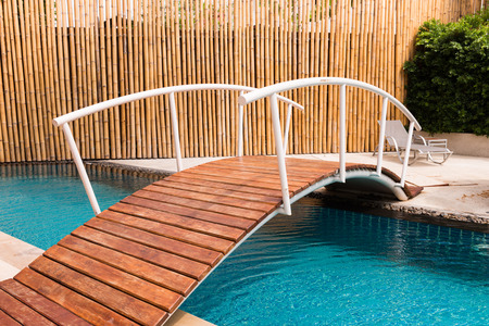 Bridge over the swimming pool in resortの写真素材