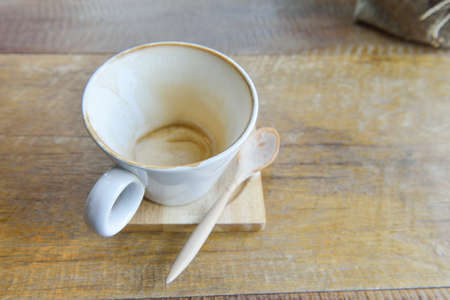 empty latte coffee  cup mug on wooden tableの写真素材