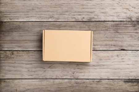 Cardboard box on a  wooden background