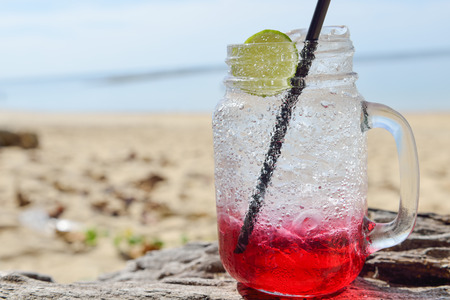 red spirit drink lemon soda cocktail on the beachの写真素材
