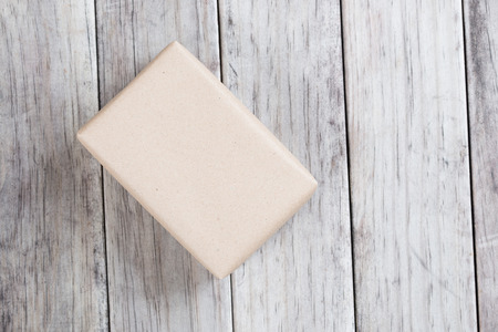 Cardboard box on a wooden background, Brown mail package parcel wrap delivery