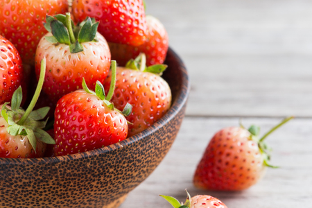 Strawberries with leaves on a wooden background , bleed Royal Queen but in chiang mai thailand call 80の写真素材