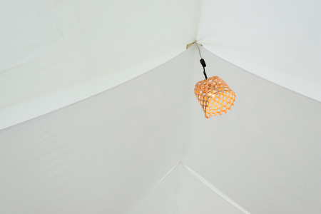 Orange Lamp in Bamboo rattan wicker  baskets in white tentの写真素材