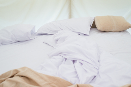 Inside a large white tent camp with bed and interior furnishingsの写真素材