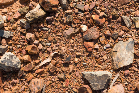 Red brown ground soil texture mixed with small rocks