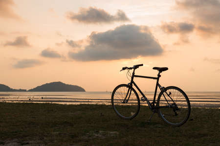 Bicycle parking on the beach at sunset sunriseの写真素材