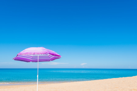 Violet parasol , purple umbrella on the beach at sunny day phuket thailandの写真素材