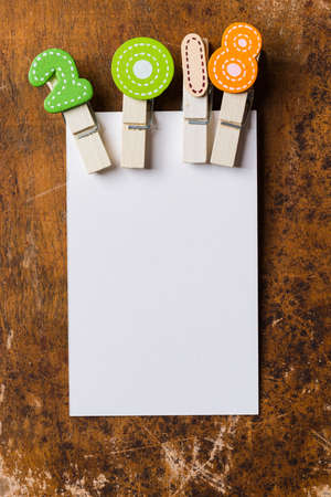 White blank card with colorful clip 2018 wood backgroundの写真素材