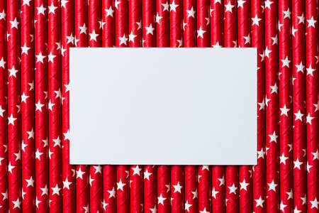 White blank card on  red white star  straw background