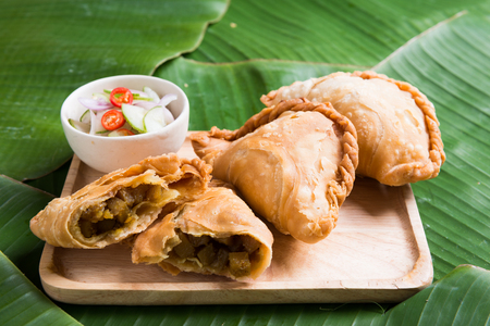 curry puff stuffed chicken on banana leaf backgroundの写真素材