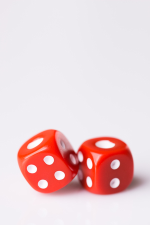 Red dice on white background with copy space