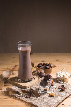 Glass of chocolate milk on table close-up with retro filterの写真素材