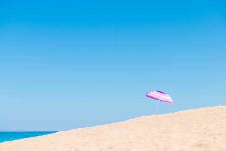 Violet parasol , purple umbrella on the beach at sunny day phuket thailandの写真素材