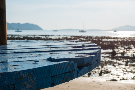 Blue table top on blurred blue sea  beach against sunshine background - can be used for display or montage your productsの写真素材