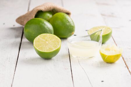 Lime on white rustic wooden backgroundの写真素材