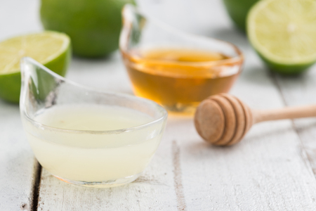 Lime mint honey and ice  refreshment healthy lemonade lime  on white wooden rustic background. selective focusの写真素材
