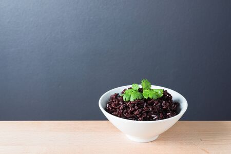 Steamed rice on white bowl wooden backgroundの写真素材