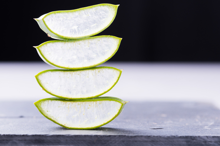 Aloe vera plant sliced on rustic rock plate with copyspaceの写真素材