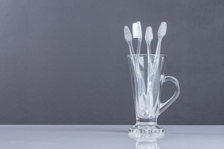 Old Toothbrush  in glass on Gray backgroundの写真素材